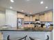 Spacious kitchen featuring stainless steel appliances, breakfast bar, and plenty of cabinet storage at 27158 W Potter Dr, Buckeye, AZ 85396