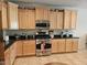 Bright kitchen with stainless steel appliances, granite countertops, and light wood cabinets at 27158 W Potter Dr, Buckeye, AZ 85396