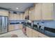 Well-equipped kitchen featuring stainless steel appliances, granite countertops, and ample cabinet space at 27158 W Potter Dr, Buckeye, AZ 85396