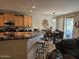 Open kitchen with breakfast bar, light wood cabinets, and an adjacent dining area at 27158 W Potter Dr, Buckeye, AZ 85396