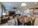 Open-concept living area with a dining table, plush seating, and a view into the kitchen at 27158 W Potter Dr, Buckeye, AZ 85396