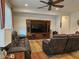 Cozy living room with ceiling fan and a wooden entertainment center at 27158 W Potter Dr, Buckeye, AZ 85396