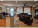 Spacious living room with large windows, comfortable seating, and an open layout to the kitchen at 27158 W Potter Dr, Buckeye, AZ 85396