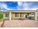 Beautiful patio with seating and outdoor grill for entertaining, shaded by a covered area at 27158 W Potter Dr, Buckeye, AZ 85396