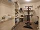 Spacious walk-in closet with shelves and fitness machine perfect for organizing clothes and exercising at 27158 W Potter Dr, Buckeye, AZ 85396