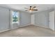 This bedroom offers a ceiling fan, carpet flooring, and natural light from the window at 3076 E Dunbar Dr, Phoenix, AZ 85042