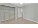 This bedroom offers a closet, carpet floors and light green colored walls at 3076 E Dunbar Dr, Phoenix, AZ 85042