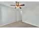 Neutral bedroom with carpet, ceiling fan, and a white door providing access to other areas at 3076 E Dunbar Dr, Phoenix, AZ 85042