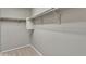 This walk-in closet offers carpet flooring, shelving and closet rods at 3076 E Dunbar Dr, Phoenix, AZ 85042