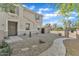 Inviting front of the two-story home featuring a low maintenance desert landscape and gated entrance at 3076 E Dunbar Dr, Phoenix, AZ 85042