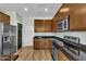 Modern kitchen with stainless steel appliances, wood cabinets, and stylish countertop at 3076 E Dunbar Dr, Phoenix, AZ 85042
