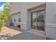 Paved patio area with stucco wall, windows, and a sliding glass door for outdoor enjoyment at 3076 E Dunbar Dr, Phoenix, AZ 85042