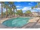 Inviting community pool with clear water surrounded by palm trees and lush landscaping for leisure at 3076 E Dunbar Dr, Phoenix, AZ 85042