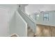 Light-filled staircase with carpeted steps, leading to an open living space with laminate floors and natural light at 3076 E Dunbar Dr, Phoenix, AZ 85042