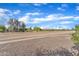 Gravel area with road behind fence, providing a view of the local street and surrounding vegetation at 3076 E Dunbar Dr, Phoenix, AZ 85042