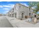 Street view of modern condo building with neutral color, individual garages, and sidewalk at 3076 E Dunbar Dr, Phoenix, AZ 85042