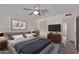 Bedroom featuring a ceiling fan, wood-look floors, a mounted TV, and closet at 3248 E Windrose Dr, Phoenix, AZ 85032