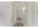 Bright hallway features wood-look floors, white walls, and closet space for storage at 3248 E Windrose Dr, Phoenix, AZ 85032