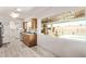 Well-lit kitchen with wood cabinetry, granite countertops, stainless steel appliances and a view of the pool at 3248 E Windrose Dr, Phoenix, AZ 85032