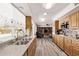 Open kitchen showcasing wood cabinets, granite countertops, stainless appliances, and view into living area at 3248 E Windrose Dr, Phoenix, AZ 85032