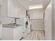 Well-lit laundry room with washer, dryer, ample cabinet space, and durable flooring at 3248 E Windrose Dr, Phoenix, AZ 85032