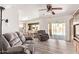 Inviting living room with wood-look flooring, plush seating, and sliding glass doors to the pool area at 3248 E Windrose Dr, Phoenix, AZ 85032