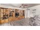 Spacious living room with built-in wood display cabinets and wood-look flooring at 3248 E Windrose Dr, Phoenix, AZ 85032