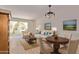 Inviting living room with ample seating, decorative lighting, and an open entryway at 3248 E Windrose Dr, Phoenix, AZ 85032