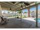 Inviting covered patio with ceiling fans, view of putting green and pool creating an outdoor oasis at 3300 N Coronado St, Chandler, AZ 85224