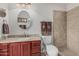 Bathroom featuring granite countertops, tile backsplash, and tile walk-in shower at 3300 N Coronado St, Chandler, AZ 85224