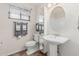 Bathroom featuring a vanity with a pedestal sink and a large mirror at 3300 N Coronado St, Chandler, AZ 85224