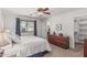 Serene bedroom with a ceiling fan, natural light, and a view into an ensuite bathroom at 3300 N Coronado St, Chandler, AZ 85224