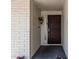 Close-up of a secure front door with security screen and brick veneer at 3300 N Coronado St, Chandler, AZ 85224