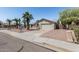 Inviting single-story home featuring a two-car garage and mature palm trees at 3300 N Coronado St, Chandler, AZ 85224