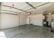 Spacious two car garage featuring overhead door, ample storage, and access door at 3300 N Coronado St, Chandler, AZ 85224