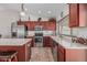 Stylish kitchen featuring stainless steel appliances, wood cabinetry, and an open layout at 3300 N Coronado St, Chandler, AZ 85224