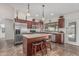Well-appointed kitchen with stainless appliances, wooden cabinets, and a center island with barstools at 3300 N Coronado St, Chandler, AZ 85224