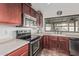 Close-up of kitchen with stainless appliances, wooden cabinets, and modern countertops at 3300 N Coronado St, Chandler, AZ 85224