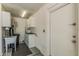 Functional laundry room with utility sink, water heater, and storage space; perfect for household tasks at 3300 N Coronado St, Chandler, AZ 85224