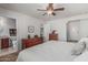 Spacious main bedroom with a ceiling fan and closet with an attached bathroom at 3300 N Coronado St, Chandler, AZ 85224