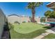 Backyard featuring a lush green putting green next to pool, perfect for golf enthusiasts at 3300 N Coronado St, Chandler, AZ 85224