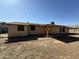 Backyard with covered patio; some windows boarded indicating possible repairs needed at 3434 W Augusta Ave, Phoenix, AZ 85051