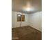 Empty bedroom requiring repairs; window is boarded and carpet shows wear at 3434 W Augusta Ave, Phoenix, AZ 85051