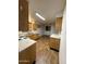 Functional kitchen with wooden cabinets, laminate countertops, and wood-style flooring at 3434 W Augusta Ave, Phoenix, AZ 85051