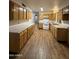 Functional kitchen with wooden cabinets, laminate countertops, and wood-style flooring at 3434 W Augusta Ave, Phoenix, AZ 85051