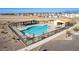 Aerial view of the fenced community pool, lounge seating, cabana and surrounding landscaping at 4050 E Brittlebush Ln, San Tan Valley, AZ 85140
