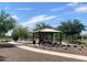Shaded gazebo with seating, surrounded by a walking path and landscaped gardens at 4050 E Brittlebush Ln, San Tan Valley, AZ 85140