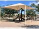 Playground with shade structure, swings, slides, and seating in a community park at 4050 E Brittlebush Ln, San Tan Valley, AZ 85140