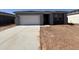 Single-story home featuring a two-car garage, neutral paint, and partial landscaping at 46904 W Coe St, Maricopa, AZ 85139