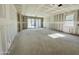 Spacious living area under construction, featuring sliding glass doors and large windows for natural light at 46904 W Coe St, Maricopa, AZ 85139